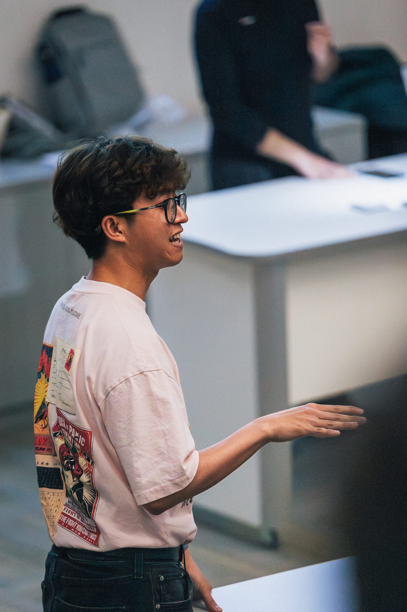 Participant mid-conversation at a workstation