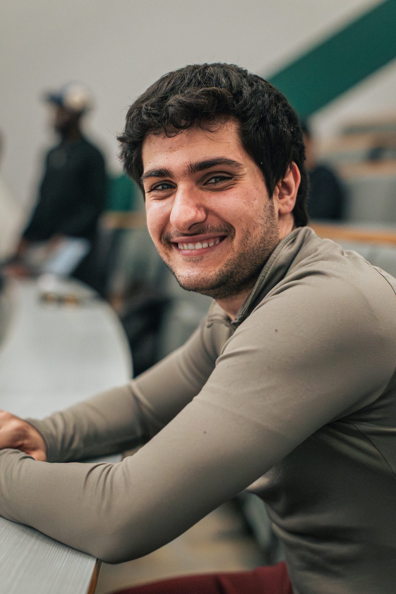 Participant in a beige jumper, relaxed and smiling on day one