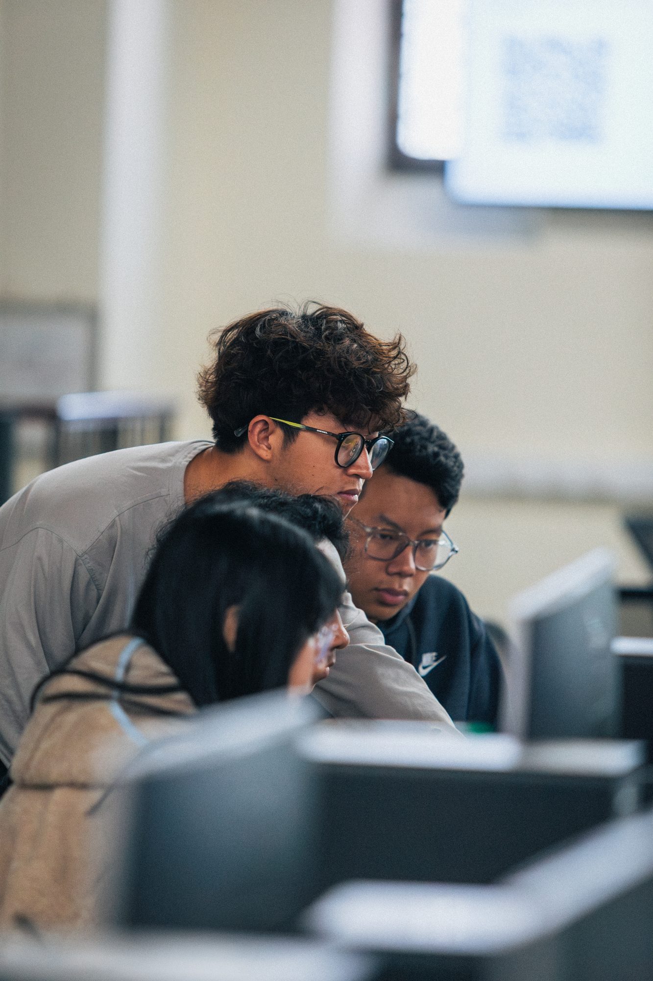 Two participants working head to head at a screen