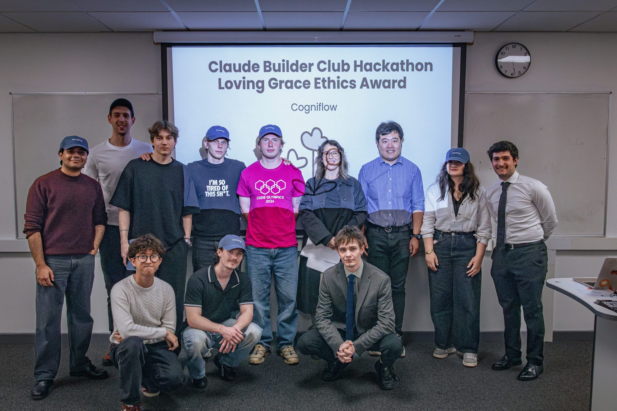 Award group photographed on stage with the Claude branding