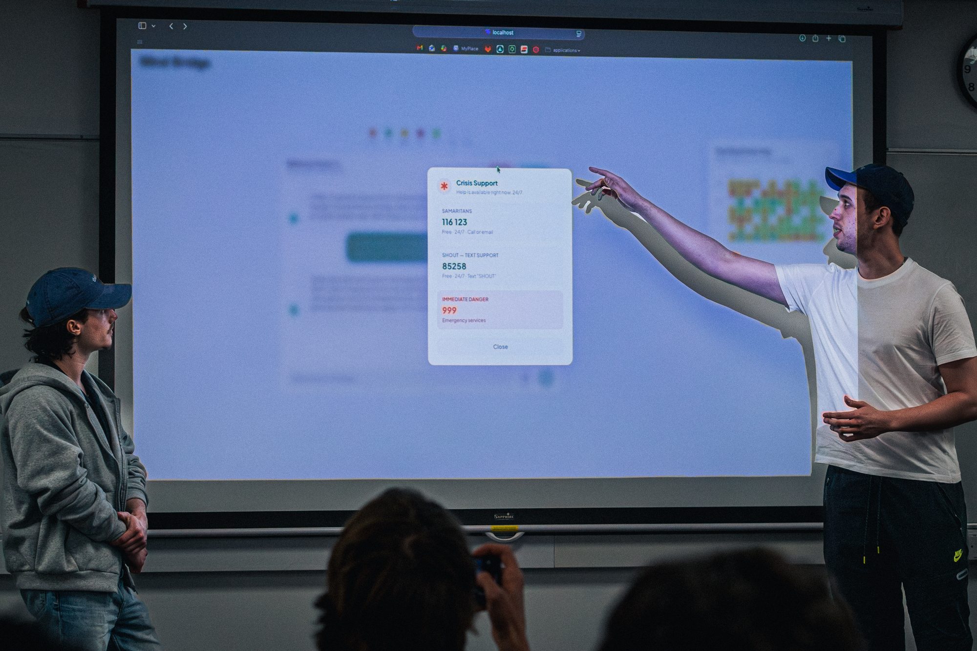 Participant demonstrating at a large touchscreen