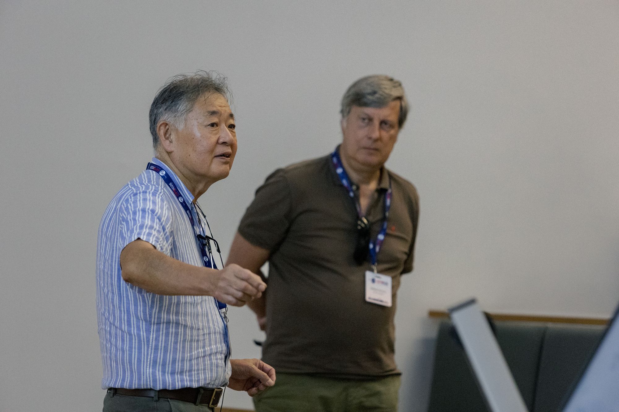 Two senior researchers reconnecting in conversation