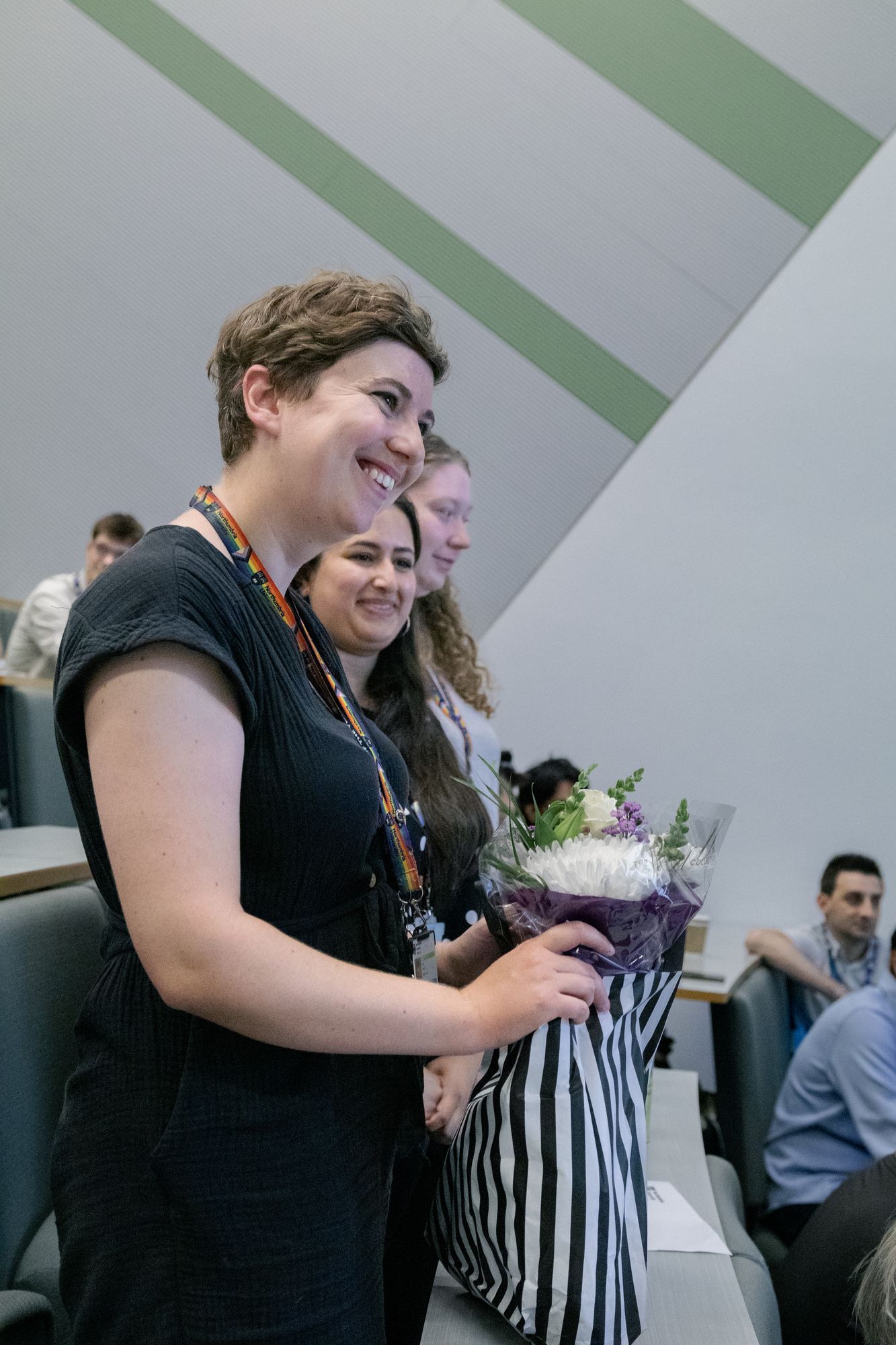 A conference organiser presented with flowers at the closing