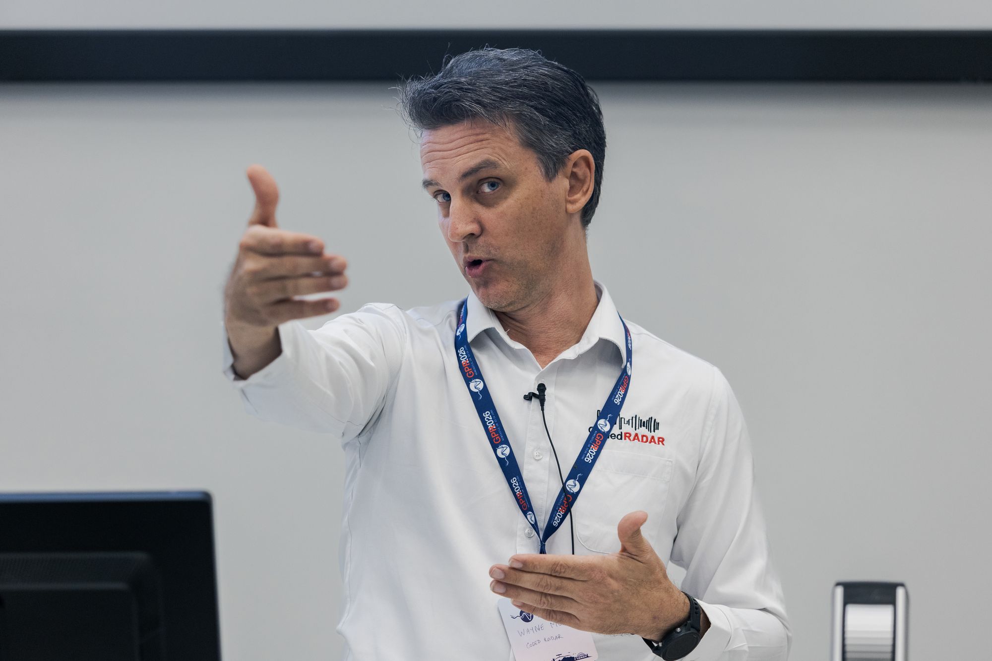A speaker presenting to the room on the opening day