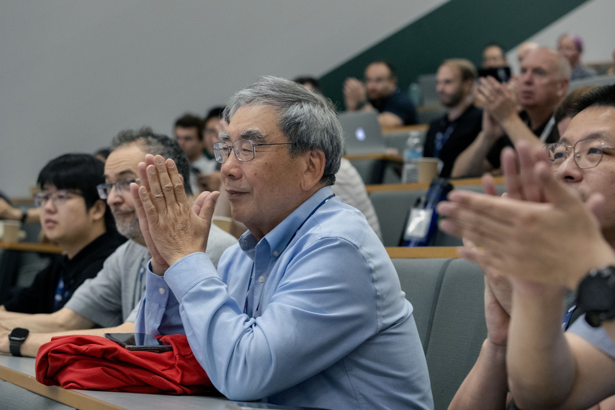 Delegates applauding during a session