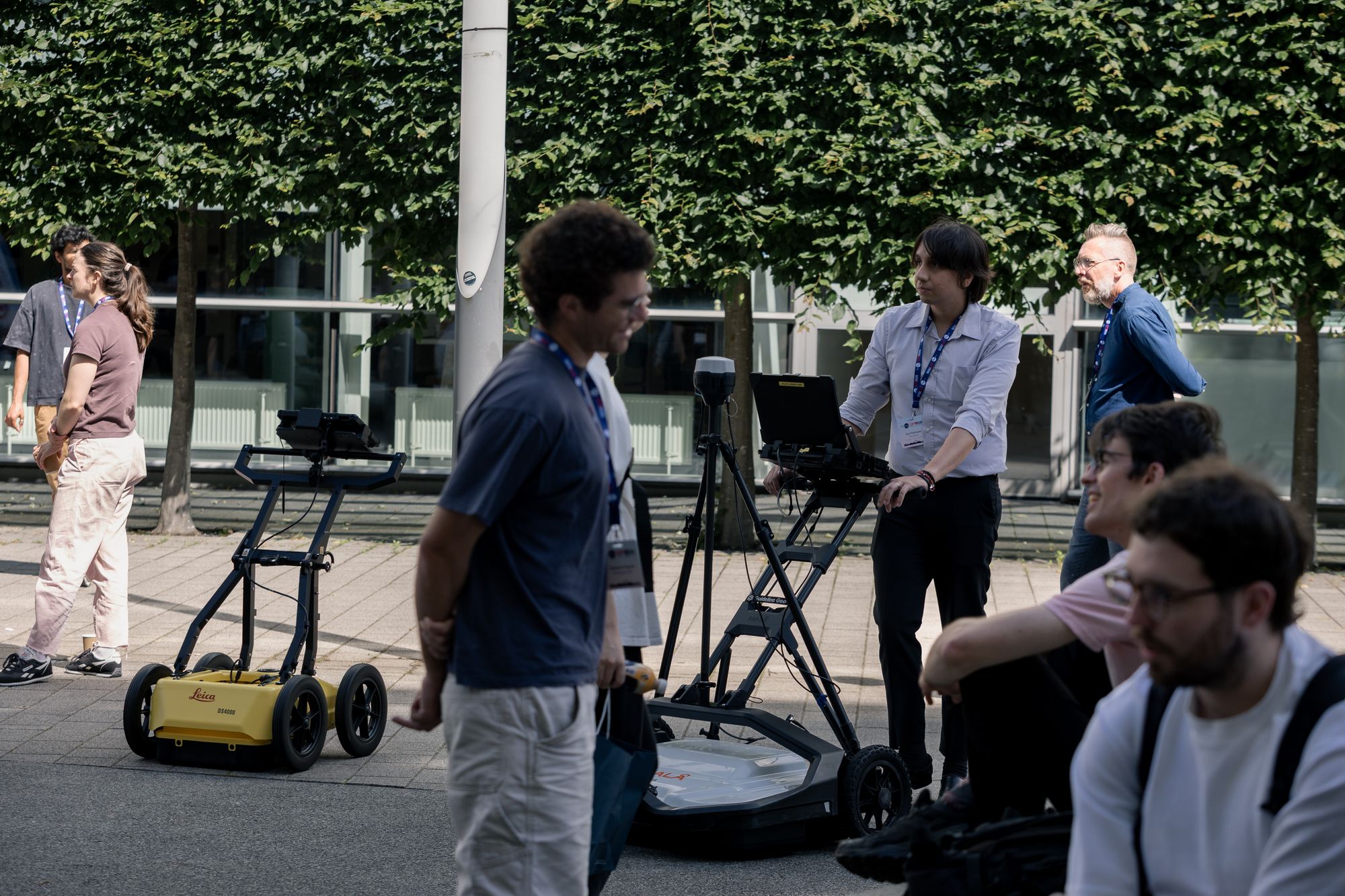 Delegates gathered around ground-penetrating-radar survey equipment during an outdoor demonstration