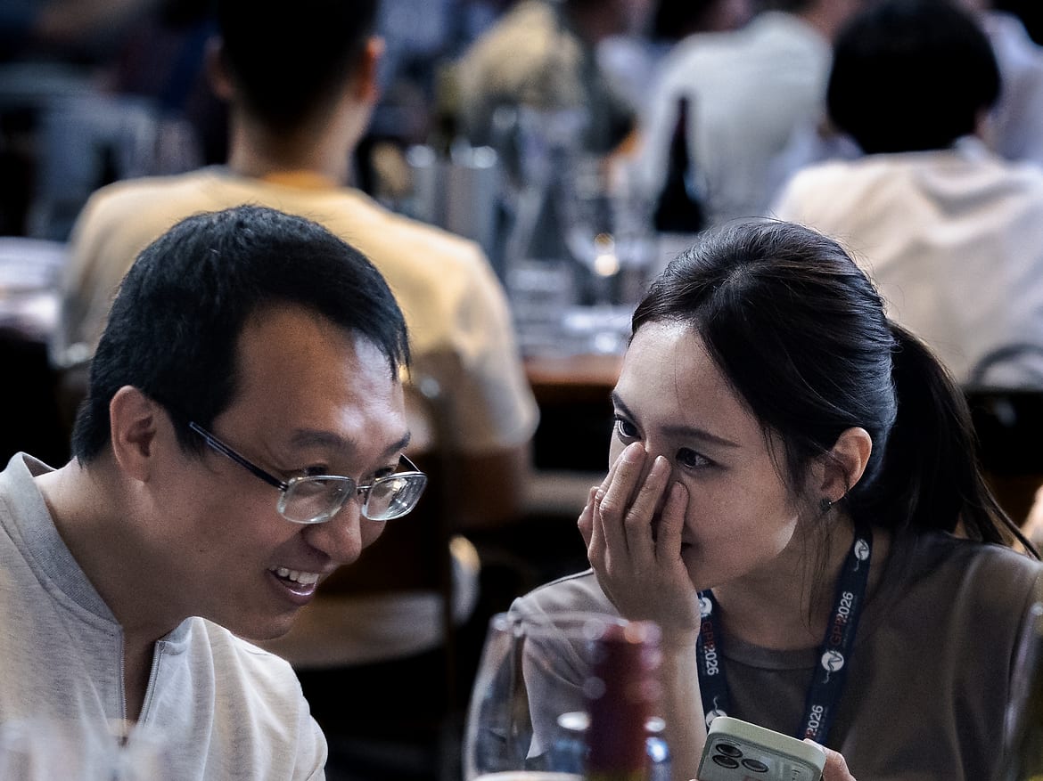 Two delegates leaning in mid-conversation over dinner at the GPR2026 conference social, Newcastle.
